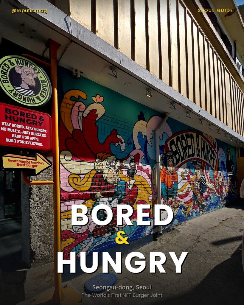 Exterior view of Bored & Hungry Seongsu, Seoul, featuring a colorful graffiti mural wall with BAYC ape characters. Text overlay reads "BORED & HUNGRY" with subtitle "Seongsu-dong, Seoul."