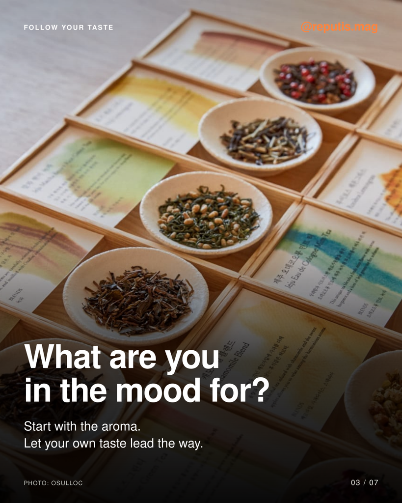 Small bowls of different tea leaves arranged on wooden trays in the tea curation area at OSULLOC Bukchon.
