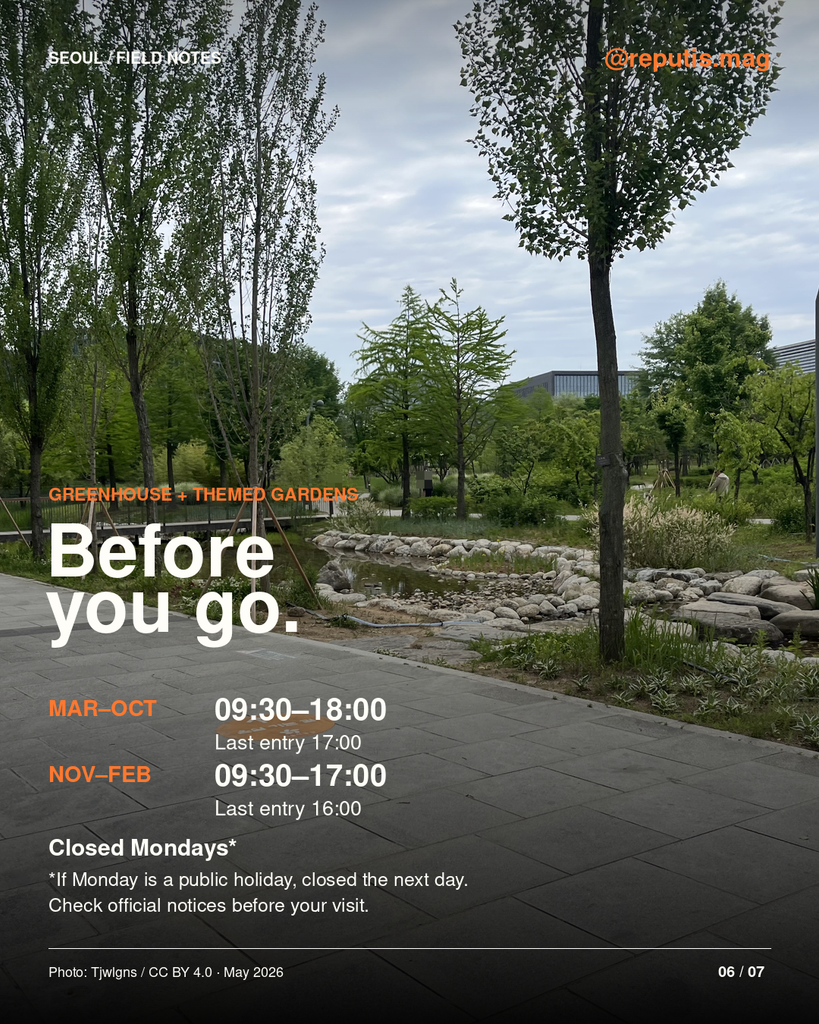 Tree-lined path at Seoul Botanic Park behind seasonal greenhouse hours: March to October 09:30–18:00; November to February 09:30–17:00. Entry closes one hour earlier. Monday closure, or the following day when Monday is a public holiday.
